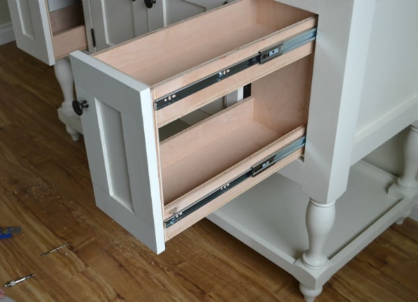 door pulls out with small tray and shelf below