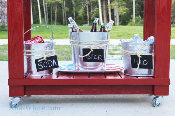 shelf on red bar cart with beverages in galvanized buckets with ice