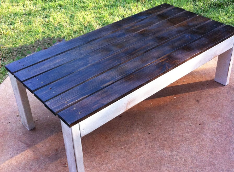 outdoor coffee table with wood stained top and white distressed base