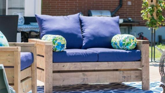 Modern outdoor loveseat with blue cushions